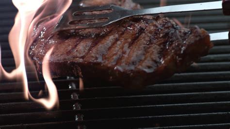 Turn all the gas grill burners to high and let it get really hot. T-bone Steak On Grill in Stock Footage Video (100% Royalty ...