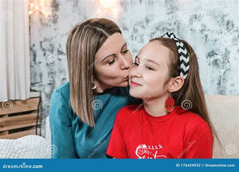 Young Mom Having Kissing Her Daughte At Christmas Photo Stock Image