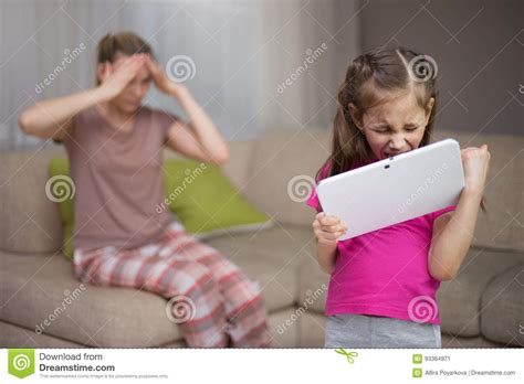Mother Frustrating That Her Daughter Playing Video Games Stock Image