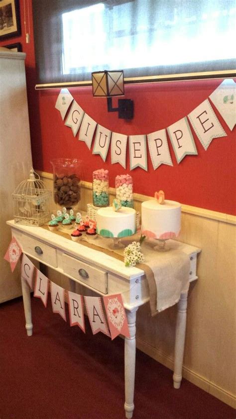 A Table That Has Some Cakes On It And Bunting In Front Of The Cake