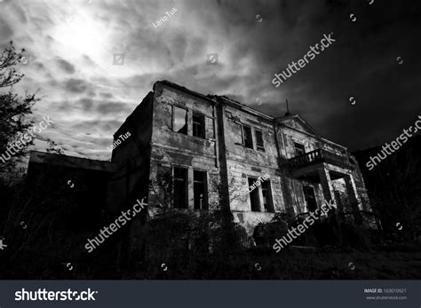 Horror Scene Of The Old Grunge Building At Night Over Cloudy Sky And