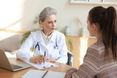 Middle Aged Female Doctor Therapist In Consultation With Patient In Office Stock Image Image