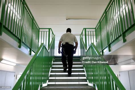 A Prison Guard Walks Through A Cell Area At Hmp Berwyn On March 15