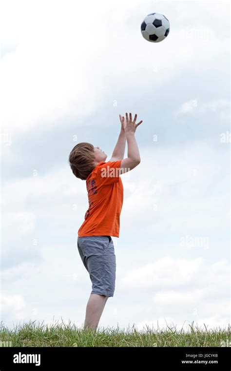Young Boy Catching A Ball Stock Photo Alamy