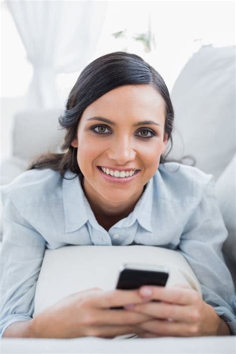 Cheerful Pretty Woman Lying On The Couch Using Her Smartphone Stock Image Image Of Mobile