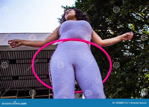 From Below A Slim Woman Plays Hula Hoop Performance On The Street Stock