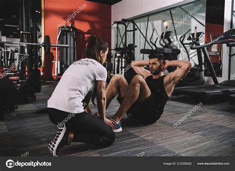 Young Trainer Instructing Handsome Sportsman Doing Push Ups — Stock