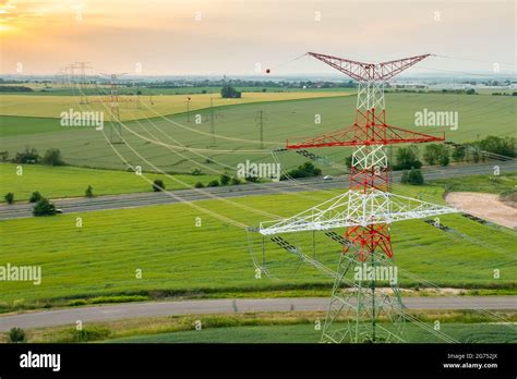 Aerial View Of Electric Power Transmission Lines At Sunset Stock Photo