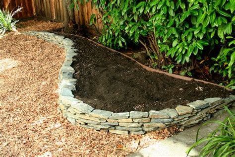 A Freshly Built Dry Stack Stone Wall And Raised Bed Ready