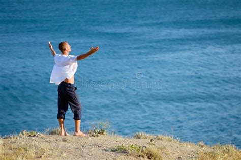 Young Man Enjoying The Sea Breeze Stock Photo Image Of Stands Male