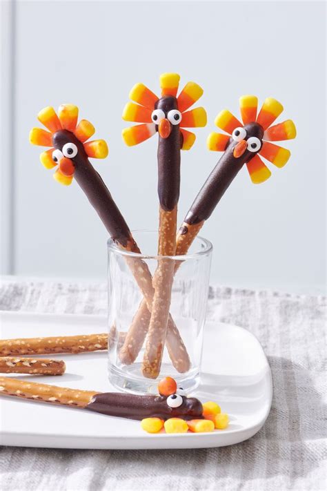 Some Pretzels Are Decorated Like Turkeys In A Glass With Candy Sticks