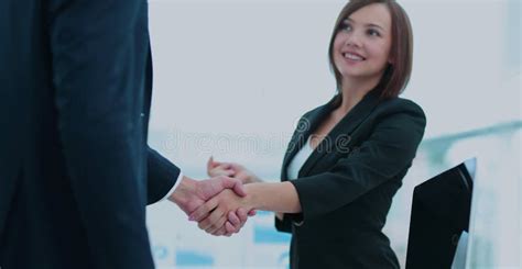 Two Business People Shaking Hands With Each Other In The Office Stock