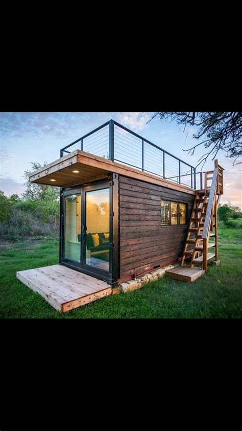 A Tiny House With Stairs Leading Up To It