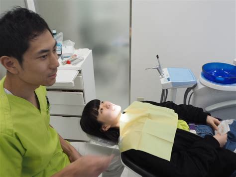 This helps to smooth it out and match the size and alignment of existing teeth. Orthodontist setting Japan straight on teeth