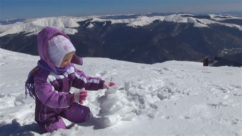 Child Playing In Snow In Mountains Little Girl In Alpine