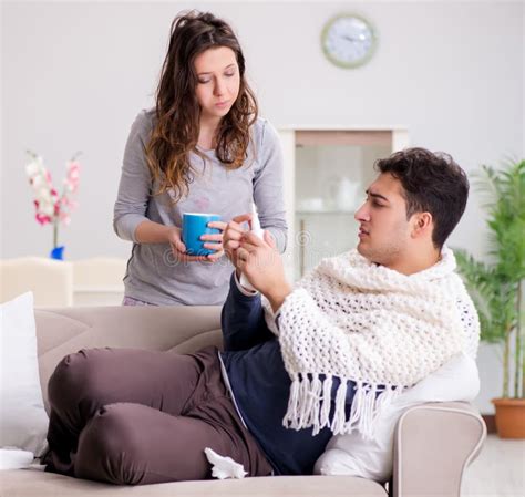 Wife Caring For Sick Husband At Home Stock Photo Image Of Couch