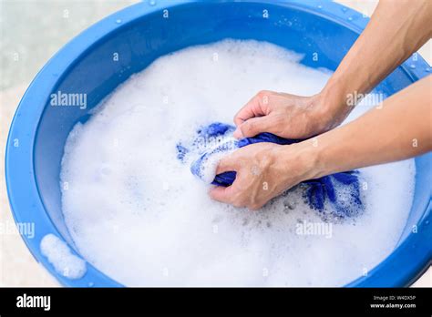 Hand Washing Clothes In Blue Basin Stock Photo Alamy
