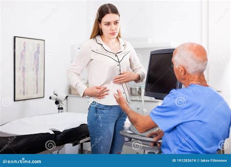 Skillful Doctor Consulting Patient Before Ultrasonography Examination