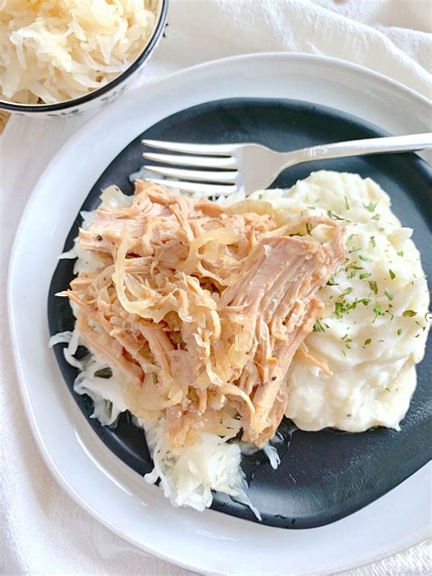 Cover the chicken with ketchup, apple cider vinegar, brown sugar, salt, pepper, paprika, cayenne, garlic powder, and worcestershire sauce. slow cooker pork and sauerkraut on plate with mashed ...