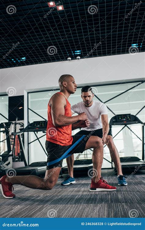 Attentive Trainer Controlling African American Sportsman Stock Photo