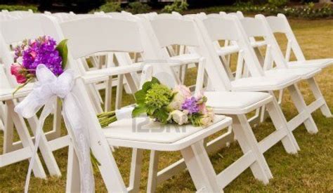 Ditch the chairs and seat your nearest and dearest in true outdoor country style. White Folding Chairs at an Outdoor Wedding with flowers ...