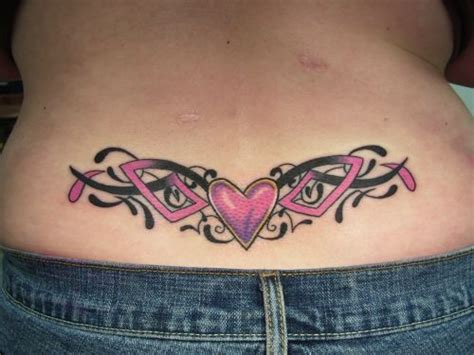 A Woman S Stomach With Tattoos On It And A Pink Heart In The Center