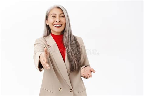 Image Of Senior Middle Aged Asian Corporate Woman Saleswoman Extending Hand Handshake Gesture