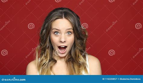 Female Face In Shock On Red Close Up Fotografering För Bildbyråer