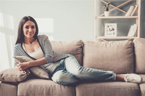 Young Smiling Woman In Jeans Lying On Sofa At Home Stock Image Image Of Repose Rest 120872705