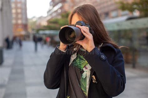 Attractive Tourist Woman Photographer With Camera Outdoor In City
