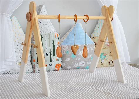 1 inch dowel rod, 2.5 feet long 4 1x2 boards, 25 inches long (we used pine) 20.5 degree cut (on. Baby gym with toys, Natural wood baby gyms toy, Montessori ...