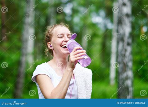Fitness Woman Drinking Water After Running Training In Summer Park