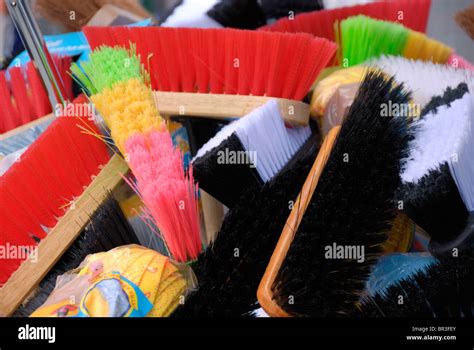 Colorful Brooms On Display Outside A Hardware Store Stock Photo Alamy