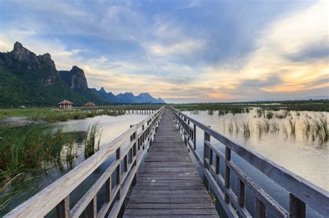 Premium Photo Wooden Bridge In Lotus Lake On Sunset Time At Khao Sam