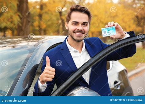 Young Man Holding Driving License Stock Photo Image Of Permission
