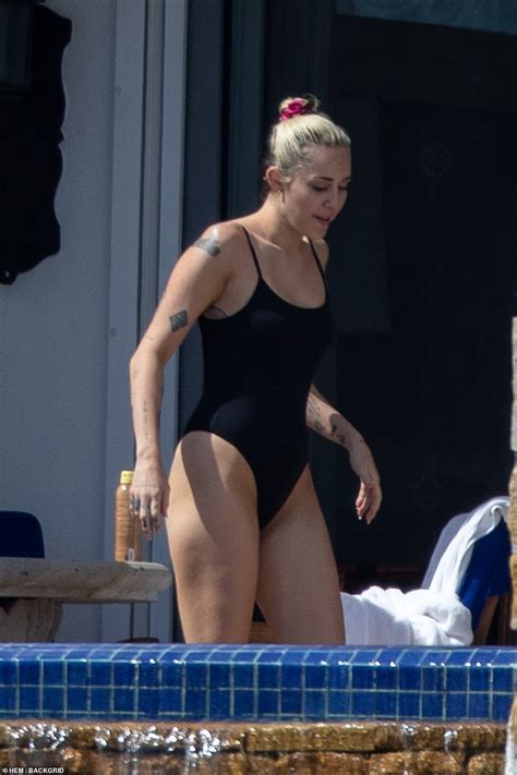 Miley Cyrus Showcases Her Legs In Bathing Suit As She Soaks Up The Sun