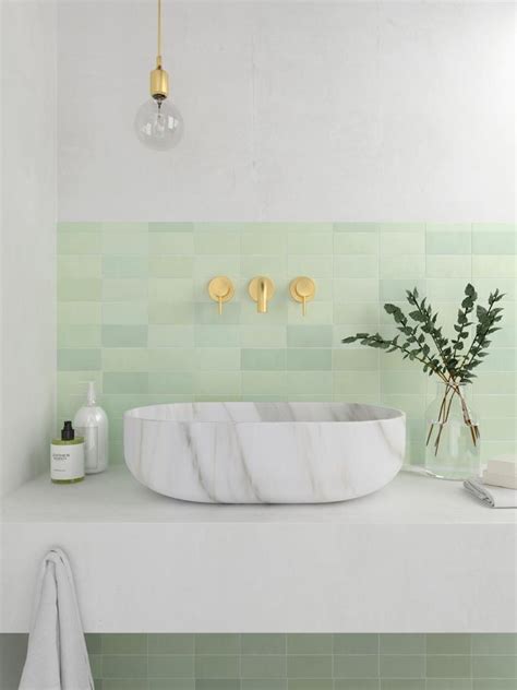 A Gorgeous Bathroom With A Marble Looking Washbasin And A Tile