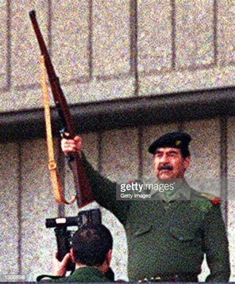 Iraqi President Saddam Hussein Raises His Rifle In A Salute And Fires Photo Dactualité