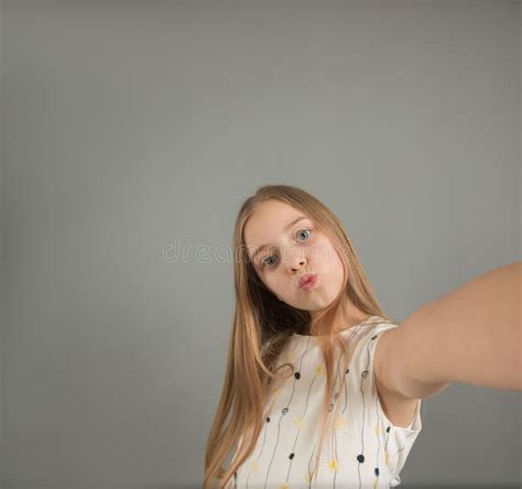 Portrait Of A Funny Young Girl Taking A Selfie With Her Arm