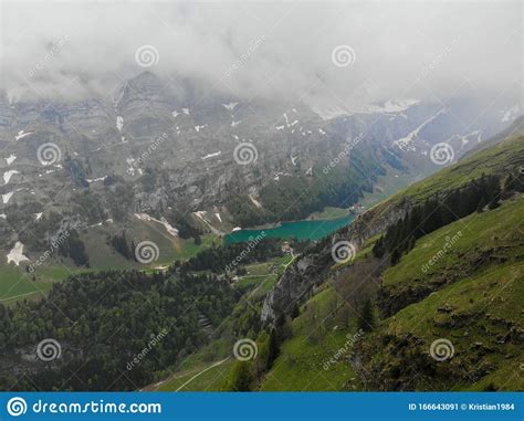 Mountains Tops With Green Trees Covered By Fog â€“ Swiss Alps Stock