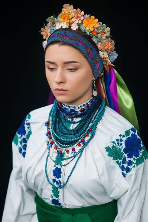a woman wearing an elaborate head piece and jewelry