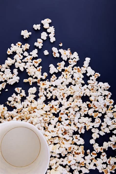 Empty Bowl With Popcorn All Popcorn Scattered On A Blue Background