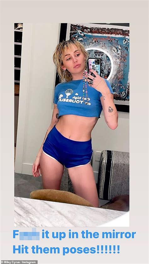 Miley Cyrus Proudly Displays Her Toned Abs In A Blue Baby Tee On