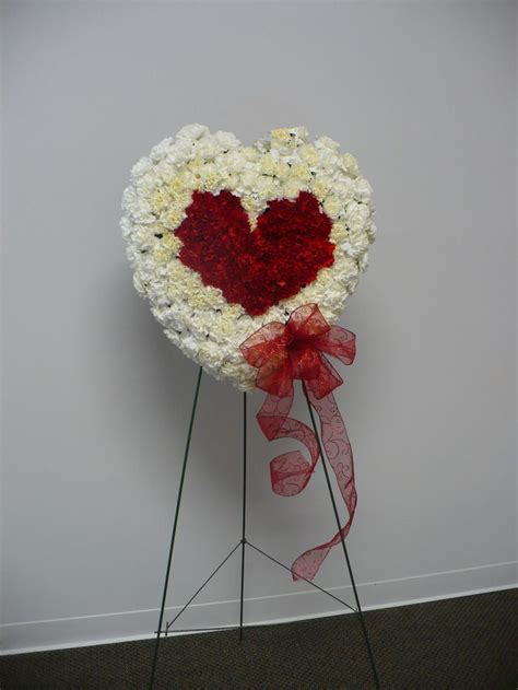 Red And White Carnations In The Form Of A Double Heart Accented With A