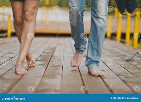 Two Pairs Of Bare Feet Treading On The Boards Of The Gangway Stock Photo Image Of