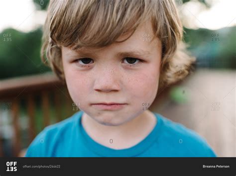 Little Boy Glaring At The Camera Stock Photo Offset