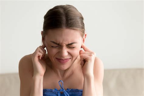 Young Annoyed Woman Sticking Fingers In Ears Not Listening Noise Stock