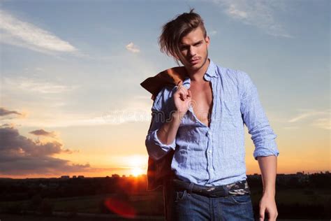 Casual Man With Hand Through Hairwith Sunset Behind Stock Image Image