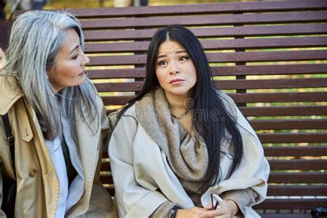Caring Woman Comforting Upset Friend On The Street Stock Photo Image