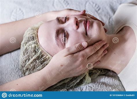 A Young Woman Gets A Relaxing Facial Massage Facial Skin Care Stock